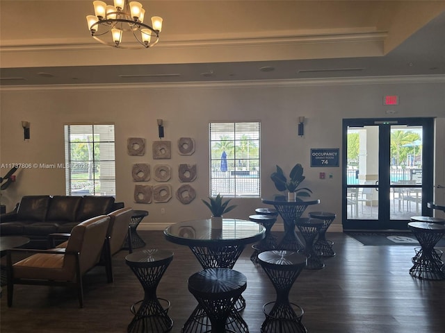 dining room featuring ornamental molding, dark hardwood / wood-style floors, and a chandelier