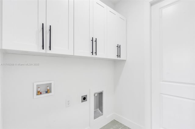 washroom featuring cabinets, washer hookup, and electric dryer hookup