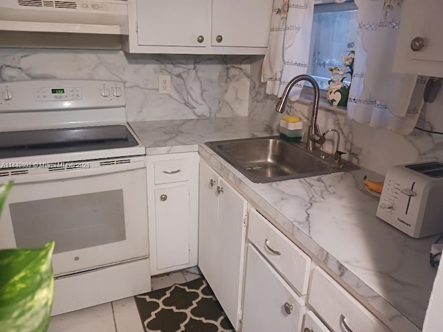 kitchen featuring electric stove, white cabinetry, sink, and tasteful backsplash