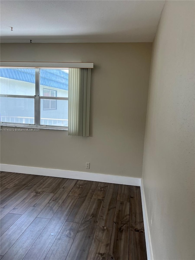 empty room with hardwood / wood-style floors