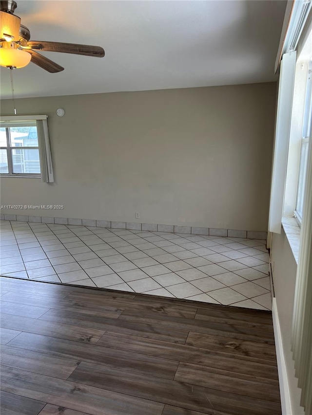 unfurnished room featuring ceiling fan and light tile patterned floors