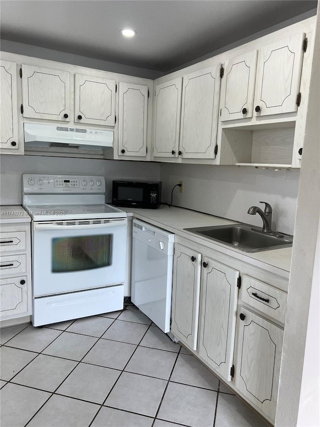 kitchen featuring sink, white appliances, light tile patterned floors, and white cabinets