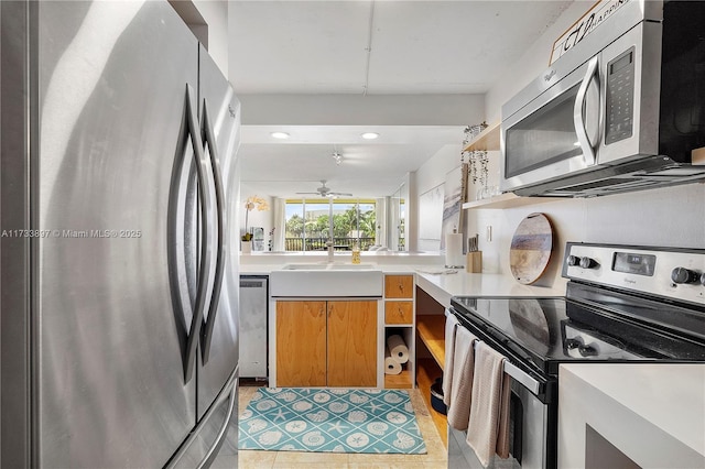 kitchen with a sink, light countertops, appliances with stainless steel finishes, open shelves, and brown cabinetry