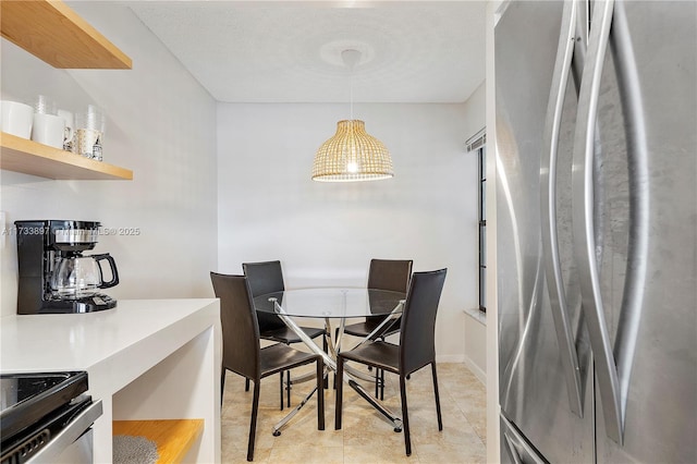 dining space featuring baseboards and light tile patterned flooring