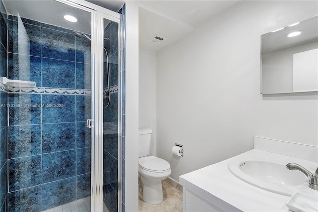 bathroom featuring toilet, tile patterned flooring, a shower stall, and vanity