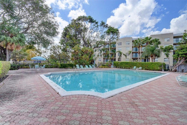 pool featuring fence and a patio