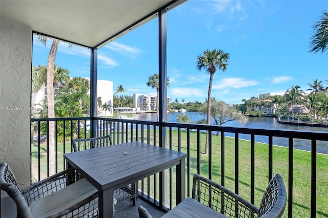 sunroom / solarium with a water view