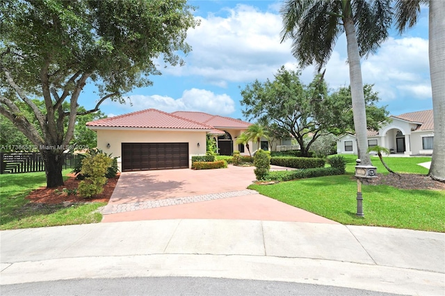 mediterranean / spanish-style home with a garage and a front lawn