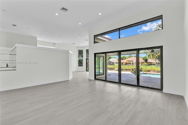 empty room with light hardwood / wood-style floors