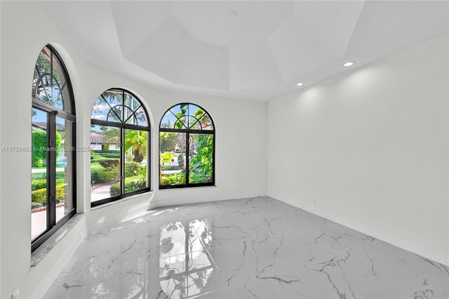 empty room featuring a tray ceiling