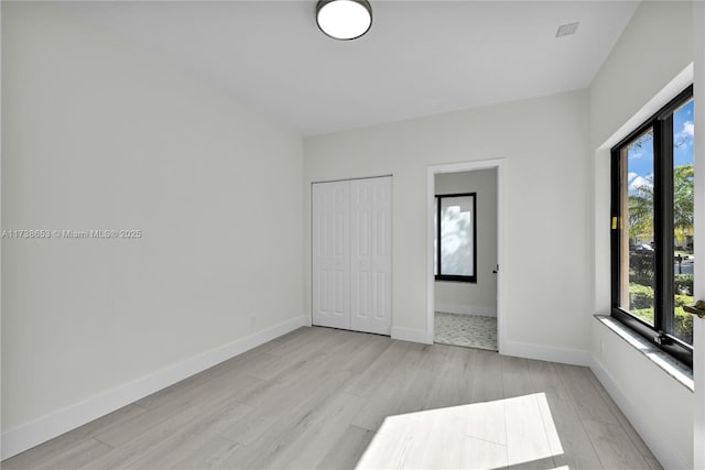 unfurnished room with light hardwood / wood-style flooring