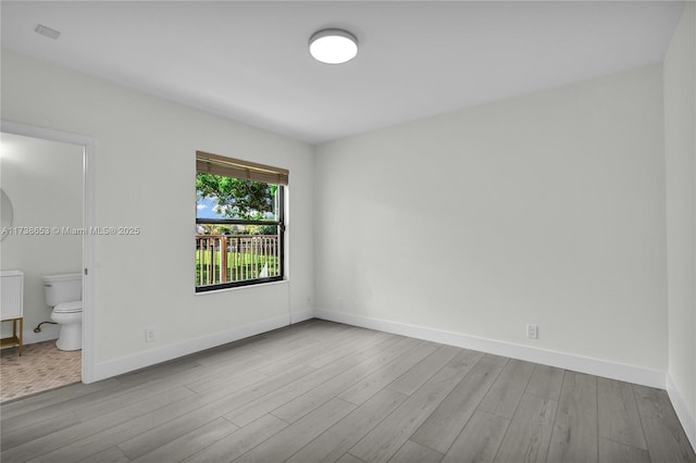 empty room with light hardwood / wood-style flooring