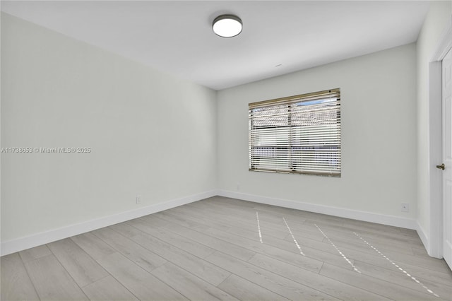 unfurnished room with light hardwood / wood-style flooring