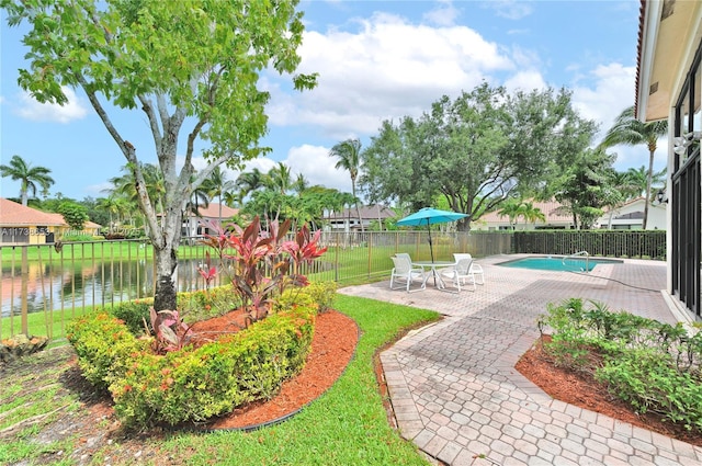 exterior space with a water view, a yard, and a patio area