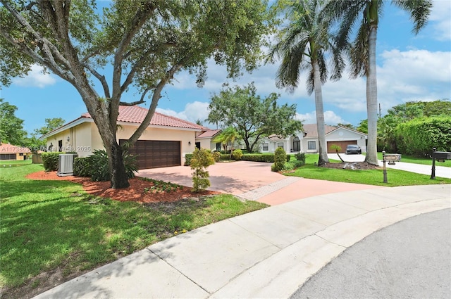 view of front facade featuring cooling unit, a garage, and a front lawn