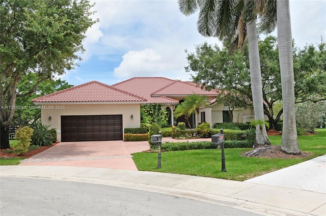 mediterranean / spanish-style house featuring a garage and a front yard