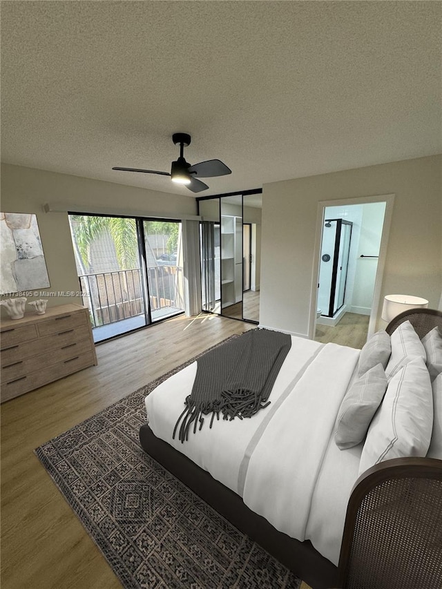 bedroom featuring ceiling fan, hardwood / wood-style flooring, a textured ceiling, and access to exterior