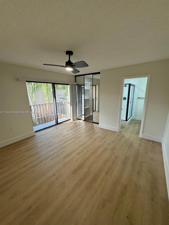 spare room featuring ceiling fan, a textured ceiling, and light wood-type flooring