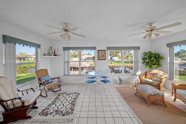 living area featuring ceiling fan and tile patterned flooring