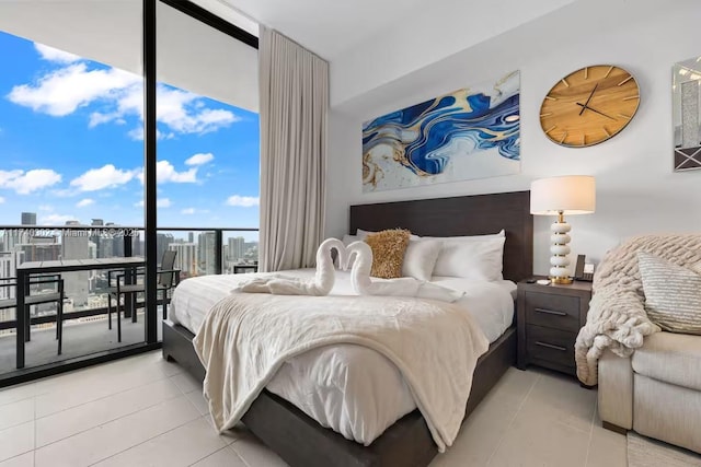 tiled bedroom featuring access to exterior and floor to ceiling windows