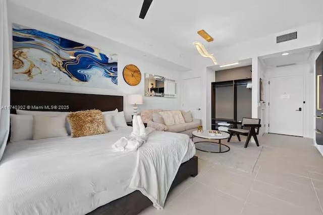 bedroom with light tile patterned flooring and ceiling fan