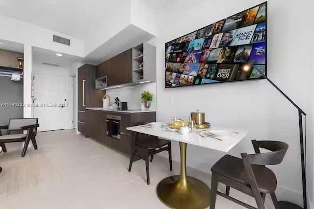 interior space featuring sink and dark brown cabinetry