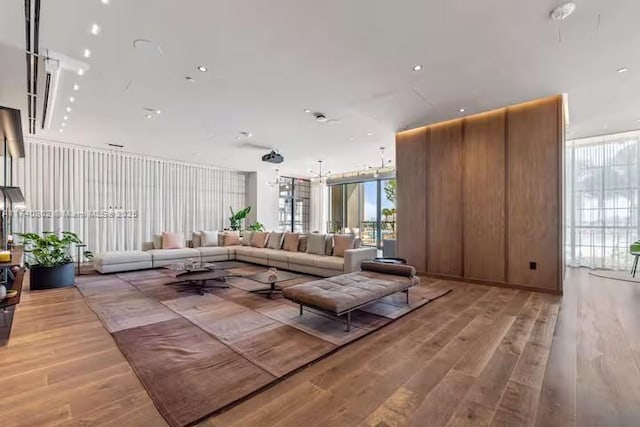 living room with hardwood / wood-style floors and expansive windows