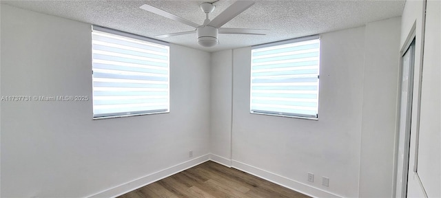 unfurnished room with a healthy amount of sunlight, hardwood / wood-style floors, a textured ceiling, and ceiling fan