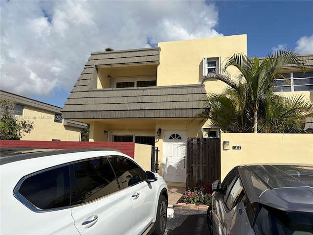 8317 SW 137th Ave Unit 8317, Miami, FL 33183 - view of front of home with stucco siding, a gate, and a balcony