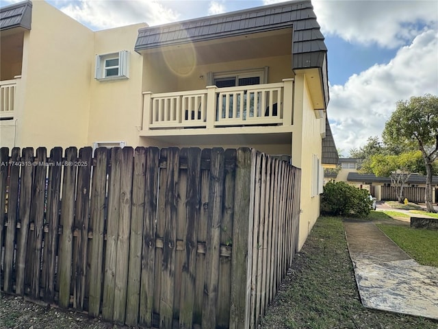 8317 SW 137th Ave Unit 8317, Miami, FL 33183 - view of home's exterior with a balcony, stucco siding, and mansard roof