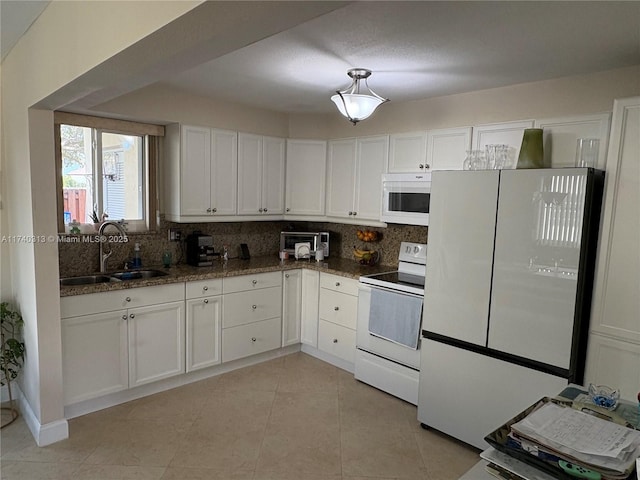 8317 SW 137th Ave Unit 8317, Miami, FL 33183 - kitchen with white appliances, white cabinetry, tasteful backsplash, and dark stone counters