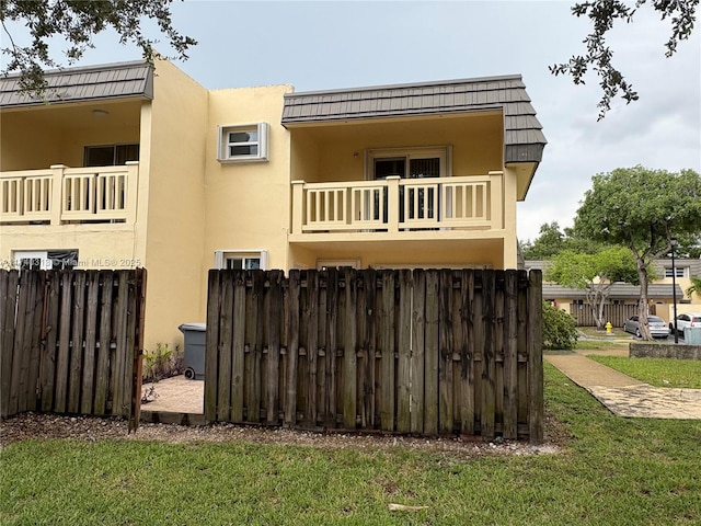 8317 SW 137th Ave Unit 8317, Miami, FL 33183 - back of property featuring a balcony, stucco siding, and mansard roof