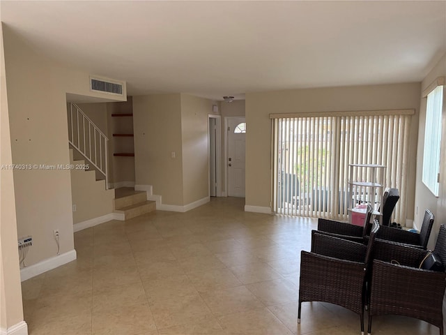8317 SW 137th Ave Unit 8317, Miami, FL 33183 - living room with stairs, plenty of natural light, and light tile patterned floors