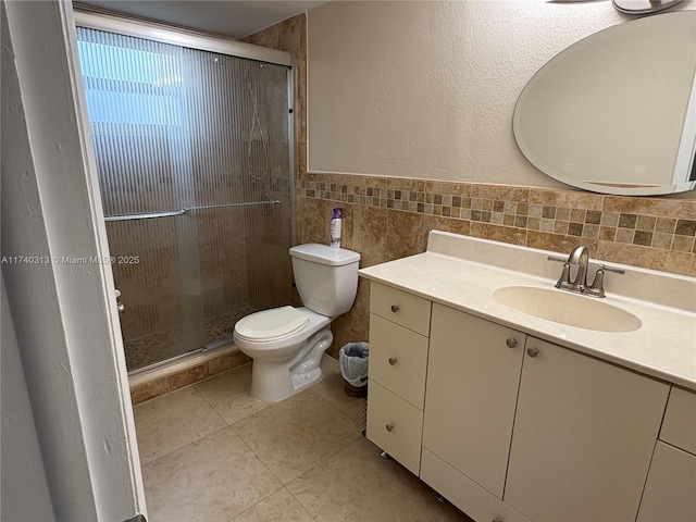 8317 SW 137th Ave Unit 8317, Miami, FL 33183 - bathroom with tile walls, vanity, a shower stall, tile patterned floors, and a wainscoted wall