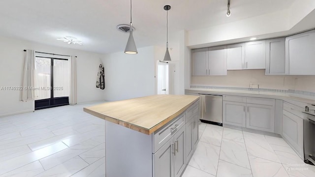 kitchen with gray cabinets, decorative light fixtures, a center island, stainless steel dishwasher, and range