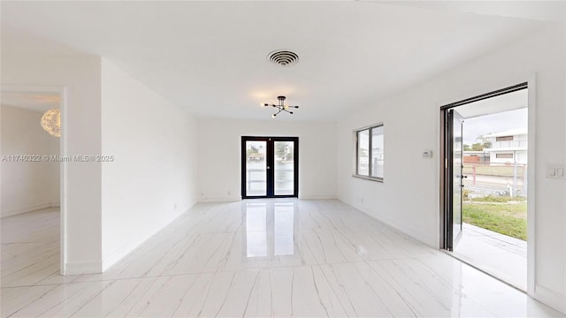 unfurnished room featuring french doors