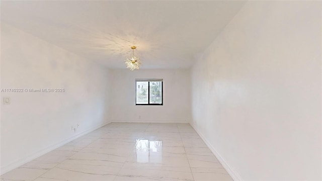 unfurnished room featuring an inviting chandelier