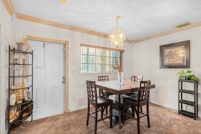 carpeted dining space featuring ornamental molding, a textured ceiling, and a chandelier