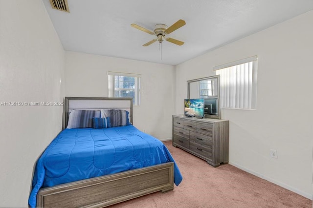 bedroom with light carpet and ceiling fan