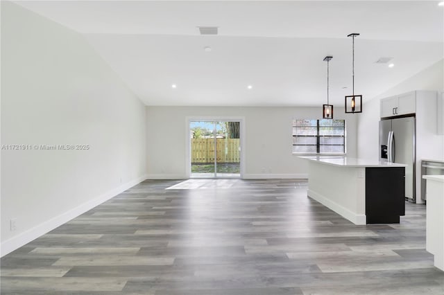 unfurnished living room with light hardwood / wood-style floors and vaulted ceiling