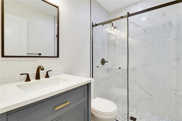 bathroom with vanity, toilet, and a shower with shower door