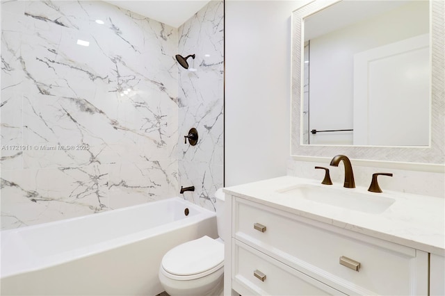 full bathroom featuring toilet, vanity, and tiled shower / bath