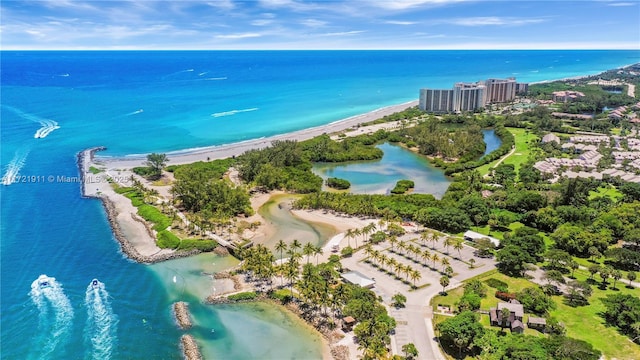 birds eye view of property with a water view and a view of the beach