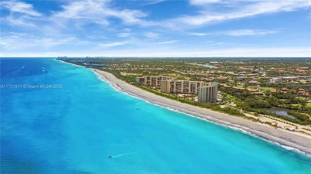 drone / aerial view with a water view and a beach view