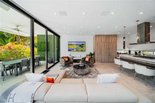 living room featuring expansive windows, a ceiling fan, and recessed lighting