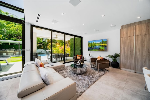 living room featuring a wall of windows and visible vents