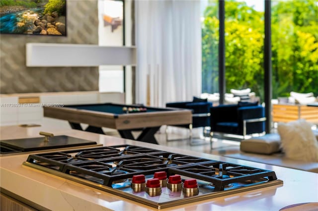 interior space with pool table and stainless steel gas cooktop