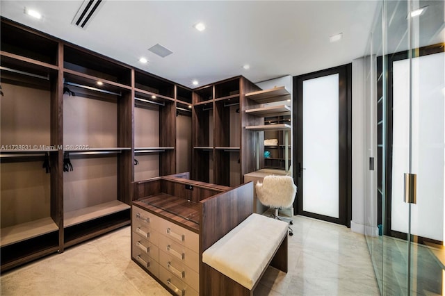 spacious closet with light tile patterned floors