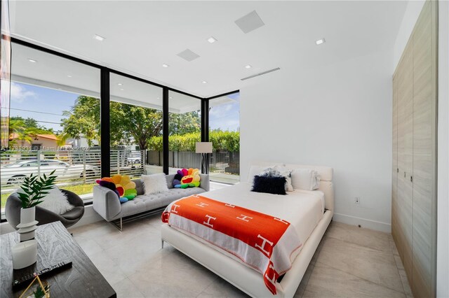 bedroom with floor to ceiling windows, access to exterior, and ceiling fan