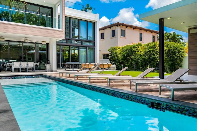 pool featuring a patio area, ceiling fan, and outdoor lounge area